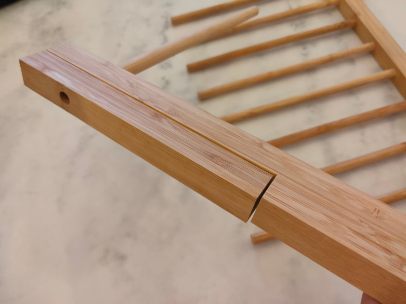 Pasta drying rack bamboo with magnetic feet keeper keeping feet in close position.
